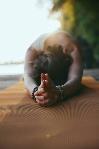istock A woman practices yoga on the dock. 1419152291