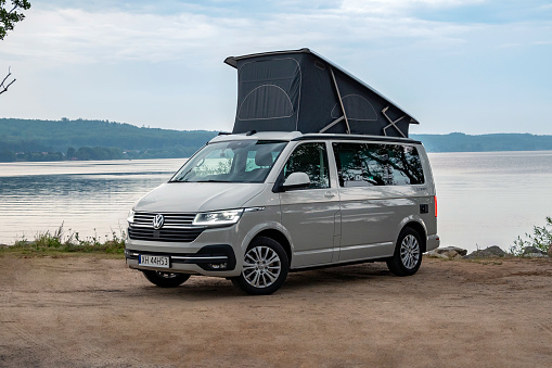 Usedom, Germany - 15th August, 2022: Motorhome Volkswagen California Ocean parked next to the lake. Today is a very popular medium-size camper vehicle in Europe.