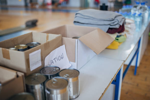 Humanitarian aid donation boxes for civilians on the floor in school gymnasium shelter, after natural disaster happened in city.
