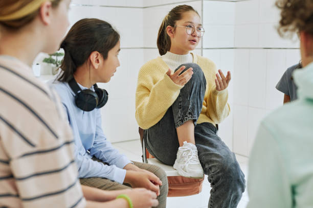 Girl Sharing in Support Group Portrait of teenage girl sharing feelings in support group circle for children 12 13 years stock pictures, royalty-free photos & images