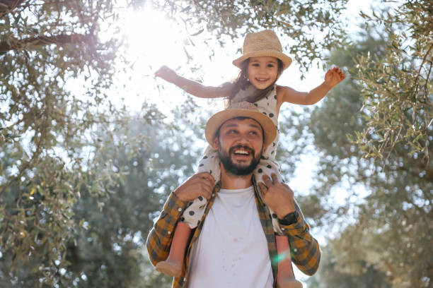 istock Father with small daughter walking outdoors by olive tree 1419157426