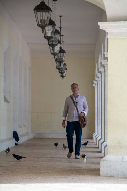 Mature man walking through the city on El Conde street in Santo Domingo, Dominican Republic.