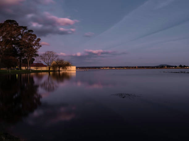 istock Boat house on lake at sunset 1419158549