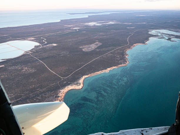 istock Looking out plane with doors off on to water and sand dunes 1419158621
