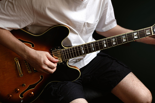 Young man playing a guitar at home