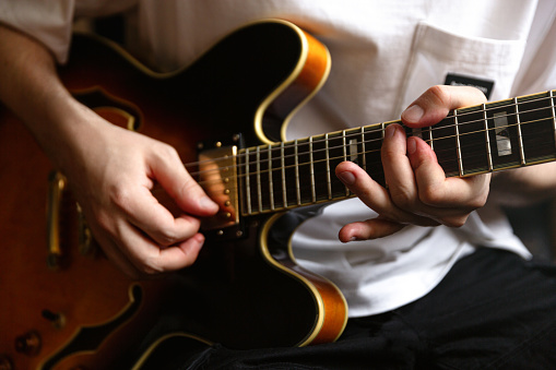 Young man playing a guitar at home