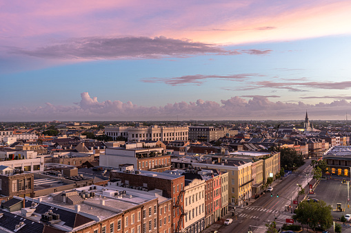 A vibrant and colorful sunrise explodes over the French Quarter of New Orleans, Louisiana in the early hours of the day.