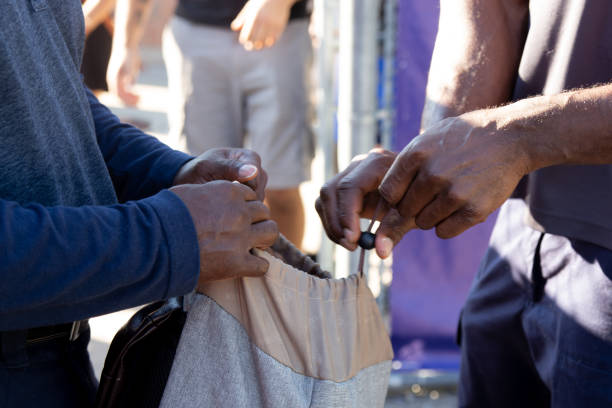 Security guard checking bag at soccer stadium
