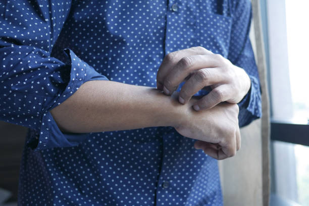 istock man suffering from itching skin, close up. 1419167268