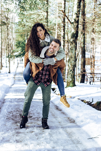 Portrait of a happy mid adult couple enjoying their romantic winter vacation on the mountain.