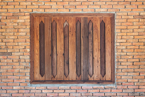 vintage old wooden window on brick wall background