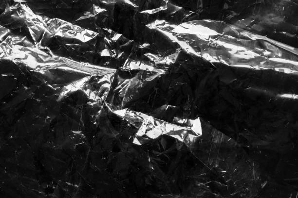 istock transparent plastic bag film wrap overlay texture on black background 1419169270