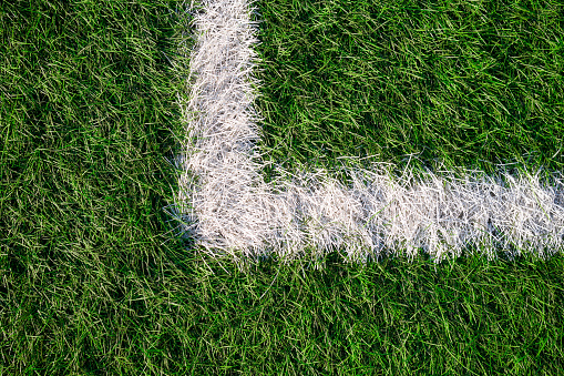 Marking of a football field. The corner of the field on artificial grass.