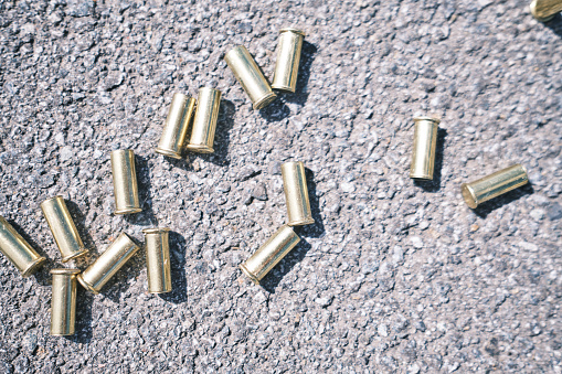 Spent cartridges from a small-caliber rifle on the asphalt