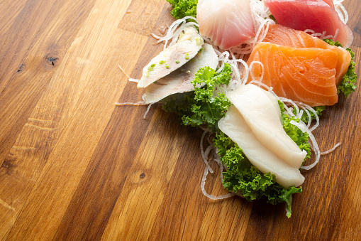 Sashimi on cutting board. Tuna, Salmon, White tuna, Mackerel, Yellow Fin