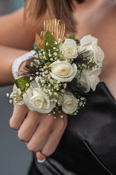 High School Girl Shows Off Pretty Corsage For Prom Date An unidentified high school girl shows off her wrist corsage given to her by her prom date. prom photos stock pictures, royalty-free photos & images