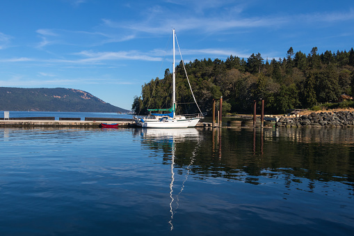 Calm water and blue skies along the shores of Cowichan Bay, located on southern Vancouver Island.
