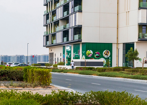 Nouakchott, Mauritania - July 19, 2014: traffic moving along Abdel Nasser Avenue with the Army HQ on the left and the Accounting School on the right