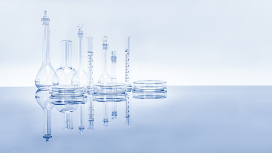 composition of varieties of laboratory glassware for scientific research and experiment chemistry pharmaceutical biotectnology biology cosmetic and education with reflection