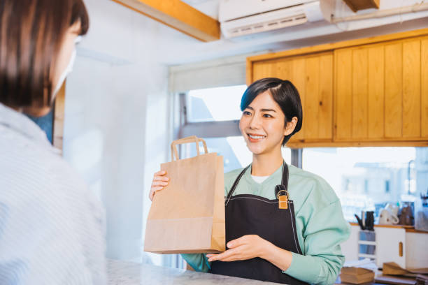 istock Female clerk handing over products 1419184137