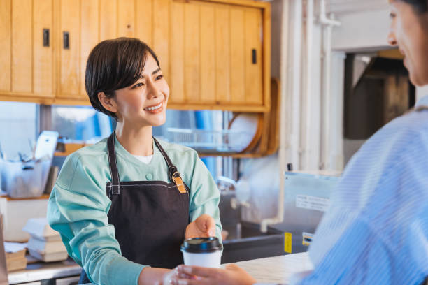 istock Clerk giving takeout coffee (coffee stand / cafe) 1419184370