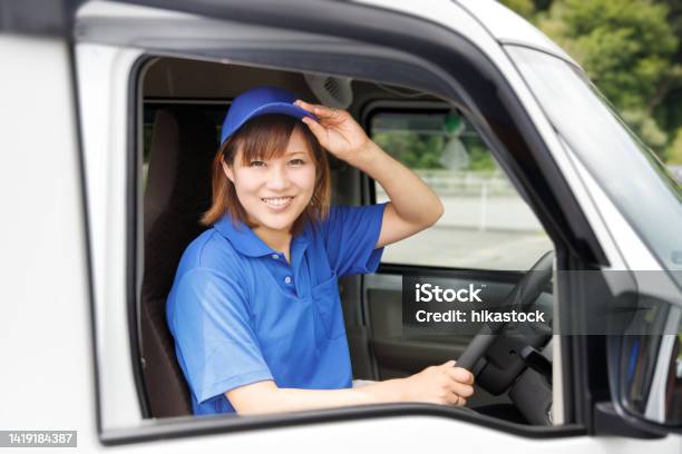 Female Driver Delivers Packages With A Smile The Image Of A Logistics Delivery And Moving Company Stock Photo - Download Image Now