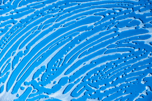 istock Top view of a blue surface covered with soap foam. 1419184413
