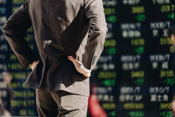 istock A man looking at a stock price board (body parts) 1419186063