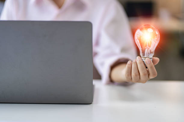 istock Innovation through inspiring ideas human hand holding a light bulb and creative Inspiration for sustainable business development, energy saving concept. 1419191937