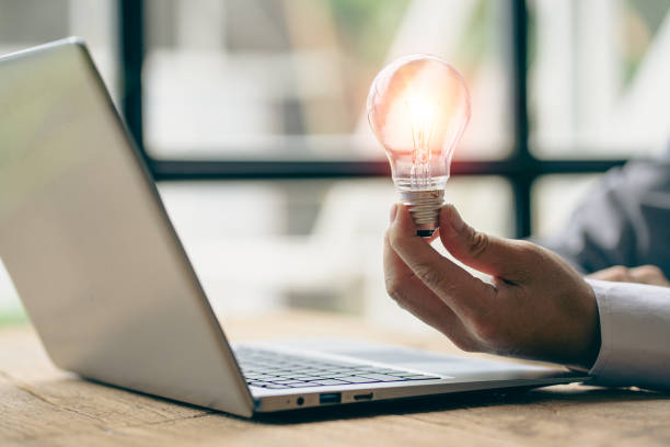 istock Innovation through inspiring ideas human hand holding a light bulb and creative Inspiration for sustainable business development, energy saving concept. 1419191943