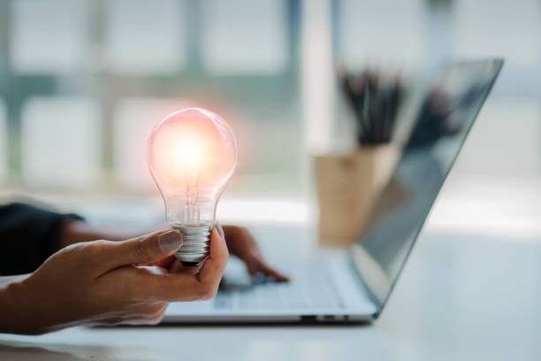 istock Innovation through inspiring ideas human hand holding a light bulb and creative Inspiration for sustainable business development, energy saving concept. 1419192014