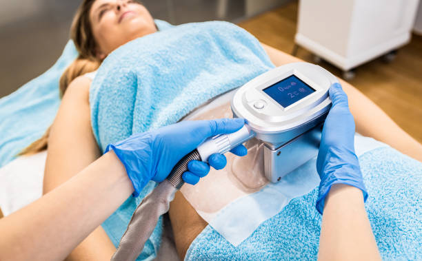 Beautician therapist applying cryolipolysis treatment in beauty salon. stock photo