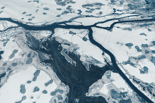 Aerial view on cracking ice on a frozen lake.