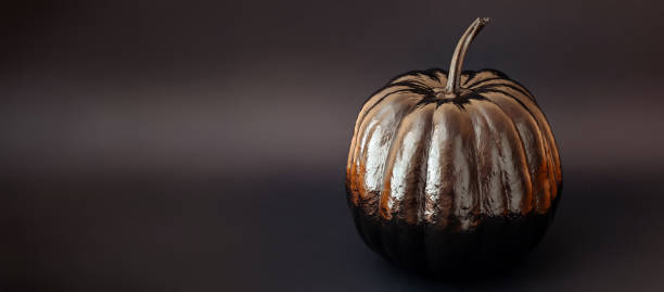 istock Painted in black Halloween pumpkin on black 1419208061