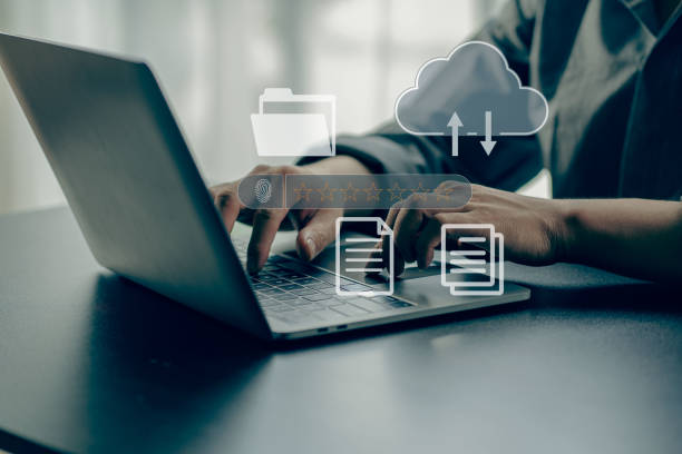 istock Businessman working on laptop with Document Management System (DMS) installed by IT consultant in office. Software for archiving, searching and managing files and data. 1419211916