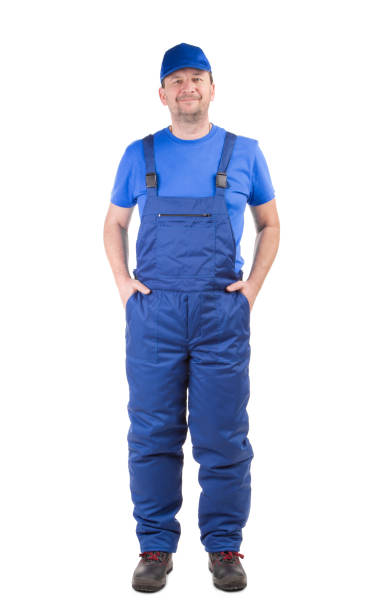 Worker in winter workwear. Worker in winter workwear. Isolated on a white background. Close-up. bib overalls stock pictures, royalty-free photos & images