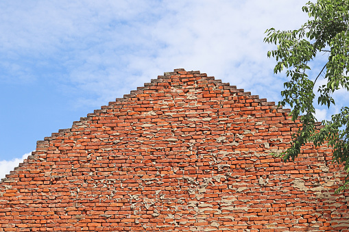 Brick wall of an old building against sky