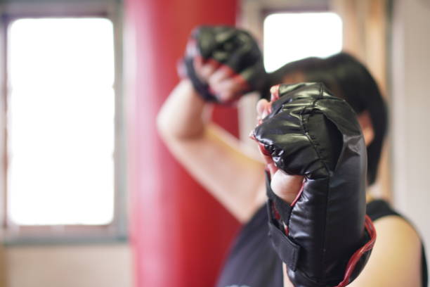 Sport: Female boxer warm-up for home workout, exercise at home, close up.