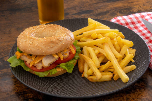 istock chicken bagel and fries on a plate 1419225928