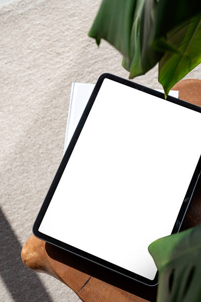 istock Digital tablet computer with isolated screen on office desk. At home interior. 1419228825