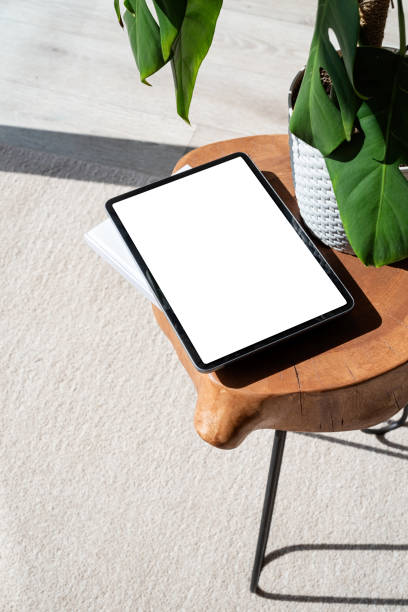 istock Digital tablet computer with isolated screen on office desk. At home interior. 1419228870