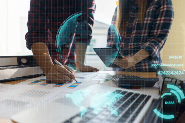 istock Brainstorm partnership of people Working for business plan Concept. smart phone and digital tablet and graph financial with social network diagram and man  and women working in the background 1419229641