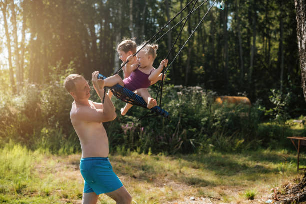 istock cute little boy having fun on a swing at playground. 1419232434