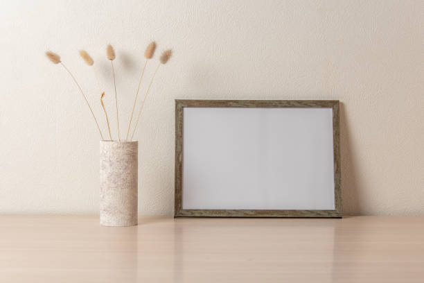 istock Template with photo frame on a wooden table. Bouquet Lagurus. Sunlight from the window. 1419233319