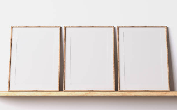 istock Modern poster frame mockup, minimal room design on white interior background, three wooden frames mock up 1419233843