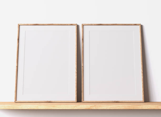 istock Modern poster frame mockup, minimal room design on white interior background, two wooden frames mock up 1419233852