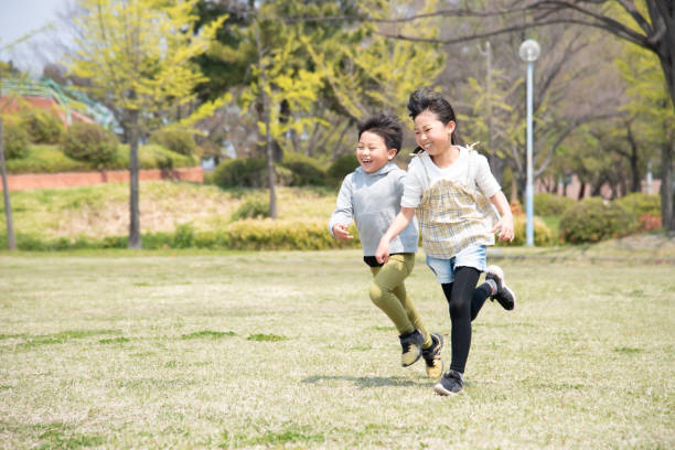 istock Sister and brother running with a smile 1419237994