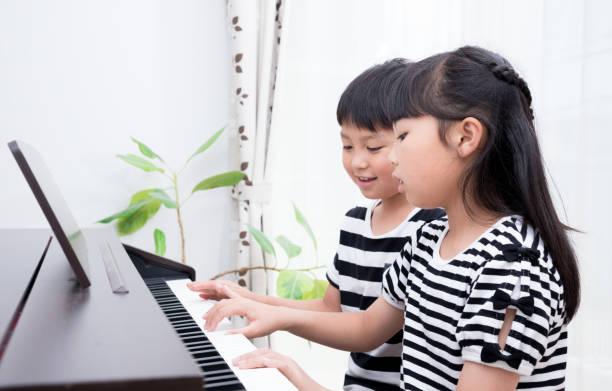 istock Japanese sister and brother practicing piano 1419238903