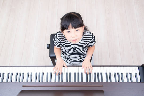 istock Japanese girl practicing piano 1419238993
