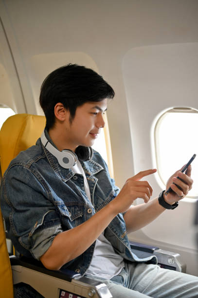 istock Portrait, Handsome Asian male passenger using his smartphone. Transportation concept 1419242156